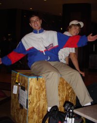 J. Nathan Matias arrives sitting on a box containing a sculpture. Jacob Kanagy is behind him.