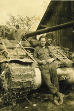 George DePuydt posing in front of his tank, WWII
